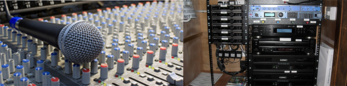 Closeup of microphone and mixing board under testing, testing a  rack full of sound gear on a service call.